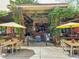 View of a charming outdoor restaurant patio with tables, chairs, lush greenery, and a welcoming atmosphere at 1431 Courtland Dr, Raleigh, NC 27604