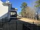 Backyard featuring a wrought iron fence and a screened-in porch on the house at 145 Plantation Dr, Youngsville, NC 27596
