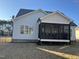 Exterior view of a screened in porch with a dark trim and ceiling fan at 145 Plantation Dr, Youngsville, NC 27596