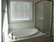 Bright bathroom with walk-in shower and soaking tub at 145 Plantation Dr, Youngsville, NC 27596