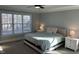 Bright bedroom featuring neutral walls, carpet, and large window at 145 Plantation Dr, Youngsville, NC 27596