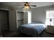 Comfortable bedroom features a ceiling fan, carpet, and double door closet at 145 Plantation Dr, Youngsville, NC 27596