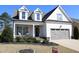 Charming two-story home featuring a welcoming front porch and a two-car garage at 145 Plantation Dr, Youngsville, NC 27596