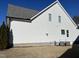 Side view of a light gray two-story home with a manicured lawn and AC units at 145 Plantation Dr, Youngsville, NC 27596