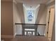 Second floor view of the foyer featuring a decorative light fixture and front door with sidelights at 145 Plantation Dr, Youngsville, NC 27596