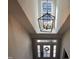 View looking up from the foyer highlighting a decorative light fixture and a large window at 145 Plantation Dr, Youngsville, NC 27596