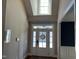 This foyer has a glass front door with sidelights, transom and skylight allowing natural light to flood the space at 145 Plantation Dr, Youngsville, NC 27596