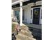 Inviting front porch with rocking chairs and stone accents leading to the entry at 145 Plantation Dr, Youngsville, NC 27596