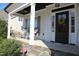 Charming front porch featuring rocking chairs, stone accents, and a welcoming front door at 145 Plantation Dr, Youngsville, NC 27596