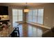 Open kitchen with breakfast nook featuring lots of windows and hardwood flooring at 145 Plantation Dr, Youngsville, NC 27596