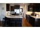 Kitchen with granite countertops, stainless steel appliances, dark wood cabinetry and eat-in counter at 145 Plantation Dr, Youngsville, NC 27596