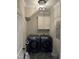 Laundry room with gray tile flooring and front loading washer and dryer at 145 Plantation Dr, Youngsville, NC 27596