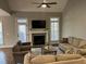 This light filled living room features high ceilings, a ceiling fan, fireplace, and access to the deck at 145 Plantation Dr, Youngsville, NC 27596