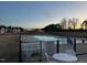 Community pool area at dusk, offering a refreshing oasis for residents at 145 Plantation Dr, Youngsville, NC 27596