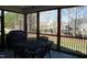 Relaxing screened porch with an outdoor dining set and a view of the backyard at 145 Plantation Dr, Youngsville, NC 27596
