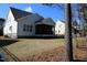 Exterior view of a home's screened-in porch and fenced-in yard with trees at 145 Plantation Dr, Youngsville, NC 27596