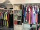 Organized walk-in closet with rods, shelving and ample storage space for clothes and linens at 145 Plantation Dr, Youngsville, NC 27596
