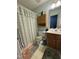 Bathroom showcasing a vanity with ample storage, floral shower curtain, and coordinating bath mat at 1454-17 Cimarron Pkwy, Wake Forest, NC 27587