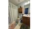 Bathroom showcasing a vanity with ample storage, floral shower curtain, and coordinating bath mat at 1454-17 Cimarron Pkwy, Wake Forest, NC 27587