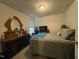 Cozy bedroom with a comfy bed, dark wood dresser, and a TV for entertainment at 1454-17 Cimarron Pkwy, Wake Forest, NC 27587