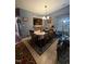 Dining room boasts natural light, wood flooring, and a decorative rug beneath the dining table at 1454-17 Cimarron Pkwy, Wake Forest, NC 27587