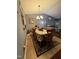Cozy dining room featuring wood table, decorative rug, and modern chandelier lighting at 1454-17 Cimarron Pkwy, Wake Forest, NC 27587