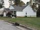 Attractive home showcasing well-kept lawn and garden with blooming bushes at 1454-17 Cimarron Pkwy, Wake Forest, NC 27587