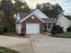 Beautiful home with brick accents, a charming front porch, and blooming landscape providing curb appeal at 1454-17 Cimarron Pkwy, Wake Forest, NC 27587
