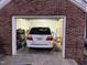 Brick garage exterior showcasing a white vehicle parked inside for secure storage at 1454-17 Cimarron Pkwy, Wake Forest, NC 27587