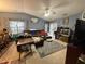 Comfortable living room features blue walls, ceiling fan, and sliding glass doors to the outdoors at 1454-17 Cimarron Pkwy, Wake Forest, NC 27587