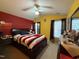 Spacious main bedroom with a king-sized bed, ceiling fan, and contrasting wall colors at 1454-17 Cimarron Pkwy, Wake Forest, NC 27587
