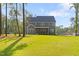 Large backyard with green grass and a view of the home's rear exterior at 1520 Banks Brooke Dr, Raleigh, NC 27603