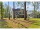 View of the backyard featuring mature trees and screened-in porch at 1520 Banks Brooke Dr, Raleigh, NC 27603