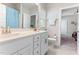 Bathroom with a double vanity, a large mirror, and white cabinets at 1520 Banks Brooke Dr, Raleigh, NC 27603