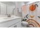 Bathroom with a white vanity, bright lighting, and a shower with a colorful curtain at 1520 Banks Brooke Dr, Raleigh, NC 27603