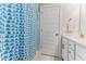 Cozy bathroom with a stylish shower curtain and a well-lit sink area at 1520 Banks Brooke Dr, Raleigh, NC 27603