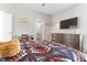 Bright bedroom with a cozy bed, desk, and dresser under a mounted TV at 1520 Banks Brooke Dr, Raleigh, NC 27603