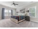 Bedroom with a wooden bed frame and three windows providing natural light at 1520 Banks Brooke Dr, Raleigh, NC 27603