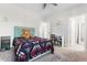 Bedroom featuring a bed, fan, closet, wall art and doorway to another room at 1520 Banks Brooke Dr, Raleigh, NC 27603