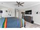Neutral bedroom features a ceiling fan, mounted television, and a large dresser for ample storage space at 1520 Banks Brooke Dr, Raleigh, NC 27603