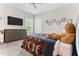 Bedroom featuring a flat screen tv, large dresser and a teddy bear on the bed at 1520 Banks Brooke Dr, Raleigh, NC 27603
