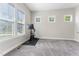 Versatile room with carpet flooring and natural light, ready for a home gym or play area at 1520 Banks Brooke Dr, Raleigh, NC 27603