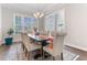 Elegant dining room with large window and stylish chandelier lighting at 1520 Banks Brooke Dr, Raleigh, NC 27603