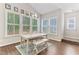 Bright dining room featuring a vaulted ceiling, large windows and hardwood floors at 1520 Banks Brooke Dr, Raleigh, NC 27603