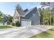 Two-story home with siding and stone accents, attached garage and long driveway at 1520 Banks Brooke Dr, Raleigh, NC 27603
