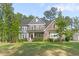 Charming two-story home with stone and siding, professional landscaping and a well-manicured lawn at 1520 Banks Brooke Dr, Raleigh, NC 27603