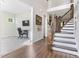 Inviting foyer with hardwood floors, staircase with iron railings, and a view into the living space at 1520 Banks Brooke Dr, Raleigh, NC 27603