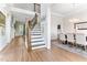 Grand foyer featuring hardwood floors, staircase with wood and iron accents, and open access to dining area at 1520 Banks Brooke Dr, Raleigh, NC 27603