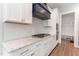 Modern kitchen features a gas cooktop, white cabinets and stone countertops at 1520 Banks Brooke Dr, Raleigh, NC 27603
