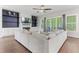 Cozy living room featuring a fireplace, built-in shelving, fan, and access to outdoor seating at 1520 Banks Brooke Dr, Raleigh, NC 27603